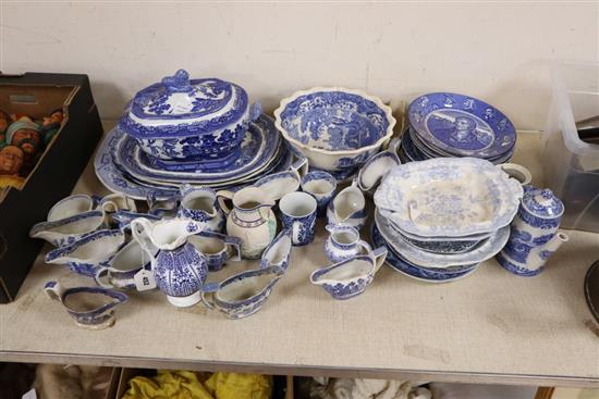 A group of 19th century blue and white pottery dishes, plates, jugs, together with an enamelled white stoneware jug